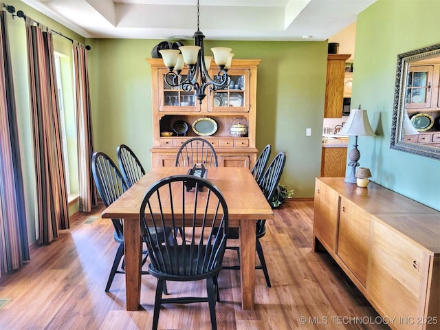 17978 W Stone Chapel Rd, Tahlequah, OK 74464 - dining room featuring a chandelier, wood finished floors, and a raised ceiling