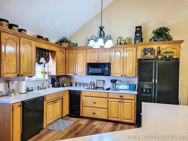 17978 W Stone Chapel Rd, Tahlequah, OK 74464 - kitchen with black appliances, wood finished floors, light countertops, a chandelier, and hanging light fixtures