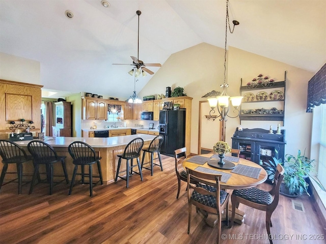 17978 W Stone Chapel Rd, Tahlequah, OK 74464 - dining area featuring a chandelier, wood finished floors, high vaulted ceiling, a ceiling fan, and healthy amount of natural light