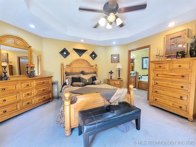 17978 W Stone Chapel Rd, Tahlequah, OK 74464 - bedroom featuring light carpet, recessed lighting, a tray ceiling, connected bathroom, and a ceiling fan