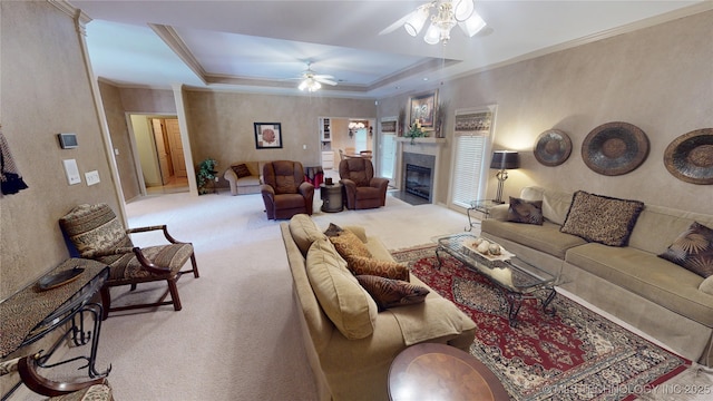 3302 Callaway Dr, Claremore, OK 74019 - carpeted living room featuring ceiling fan, crown molding, a glass covered fireplace, and a raised ceiling