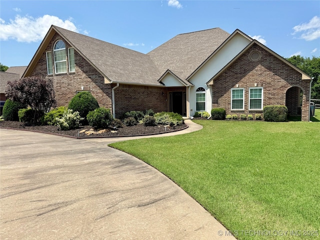 3302 Callaway Dr, Claremore, OK 74019 - view of front of property with brick siding, a front yard, and roof with shingles