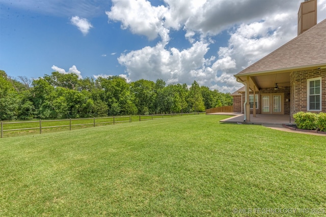 3302 Callaway Dr, Claremore, OK 74019 - fenced backyard with a ceiling fan, a patio, and french doors