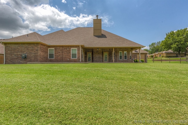 3302 Callaway Dr, Claremore, OK 74019 - back of property featuring brick siding, a chimney, and roof with shingles