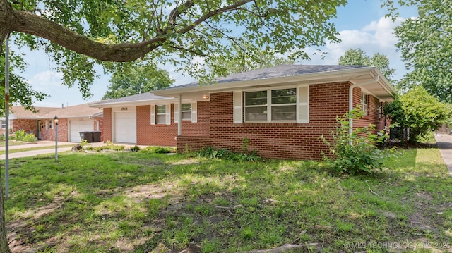 4944 Cornell Dr, Bartlesville, OK 74006 - single story home with a garage, brick siding, concrete driveway, and a front yard