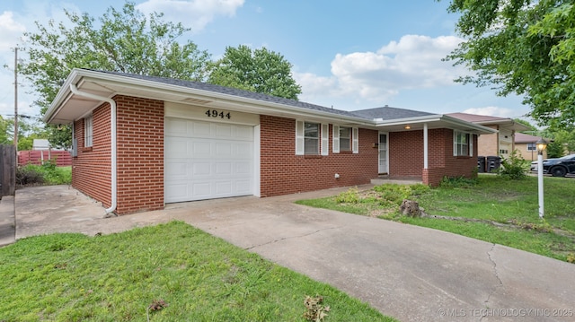 4944 Cornell Dr, Bartlesville, OK 74006 - ranch-style house featuring an attached garage, concrete driveway, and brick siding