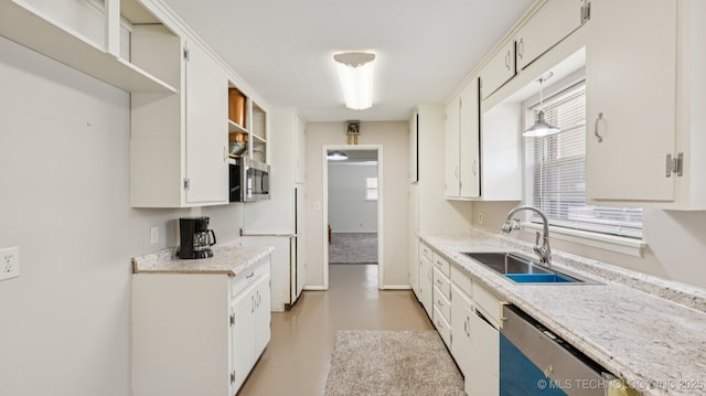 4944 Cornell Dr, Bartlesville, OK 74006 - kitchen with stainless steel appliances, light countertops, open shelves, concrete floors, and white cabinets