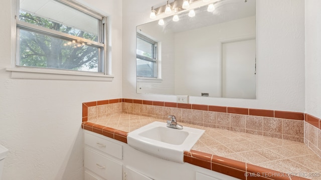 4944 Cornell Dr, Bartlesville, OK 74006 - half bathroom with vanity and plenty of natural light