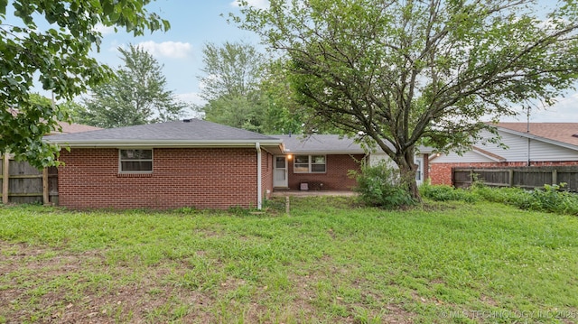 4944 Cornell Dr, Bartlesville, OK 74006 - back of house featuring brick siding and a patio
