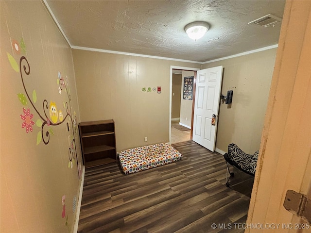 1503 Hillcrest, Durant, OK 74701 - foyer featuring dark wood-type flooring, ornamental molding, and a textured ceiling