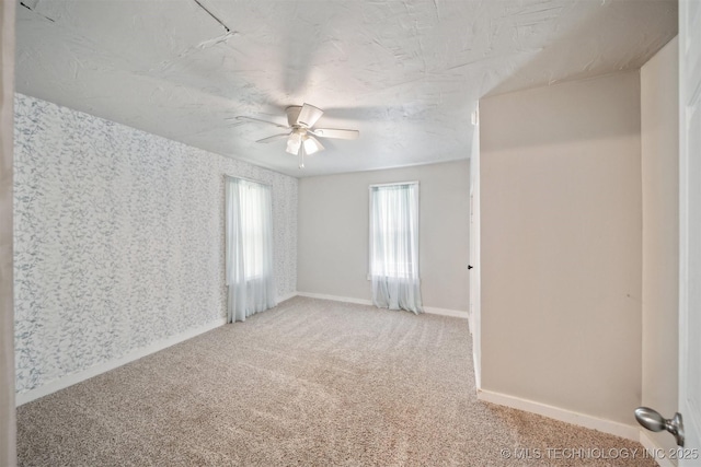 525 S 3rd Ave, Hallett, OK 74034 - unfurnished room with a ceiling fan, light colored carpet, and wallpapered walls
