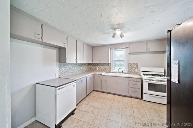 525 S 3rd Ave, Hallett, OK 74034 - kitchen with white appliances, backsplash, light tile patterned floors, and light countertops