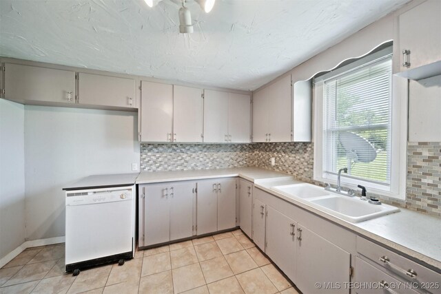 525 S 3rd Ave, Hallett, OK 74034 - kitchen featuring dishwasher, backsplash, light countertops, and light tile patterned floors