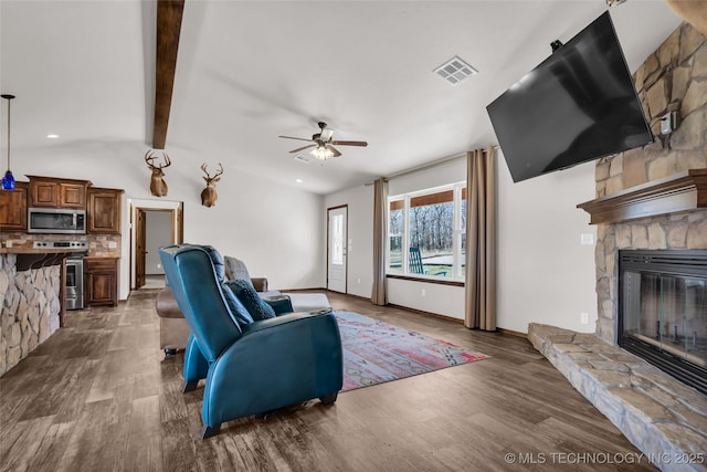 6335 S Watson, Sulphur, OK 73086 - living area with dark wood finished floors, ceiling fan, a stone fireplace, and recessed lighting