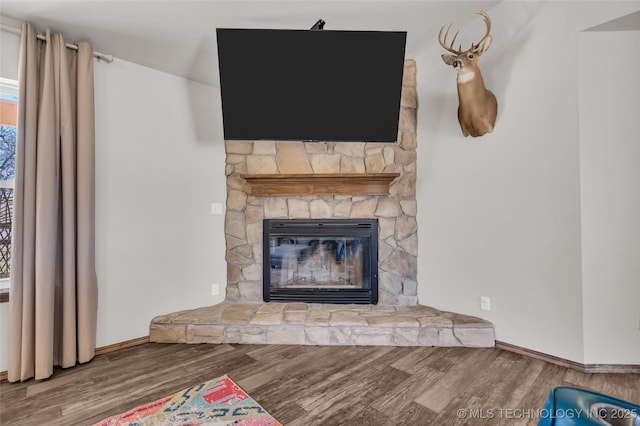 6335 S Watson, Sulphur, OK 73086 - detailed view of wood finished floors and a stone fireplace