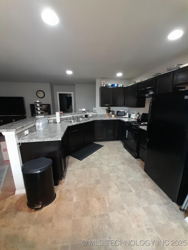 14652 S 276th E Ave, Coweta, OK 74429 - kitchen with black appliances, dark cabinets, light stone counters, recessed lighting, and a peninsula