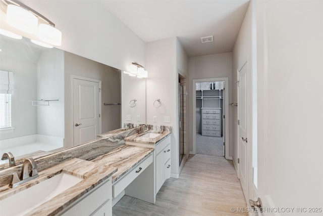 113 E 128th St S, Jenks, OK 74037 - full bath with double vanity, wood finished floors, and a spacious closet