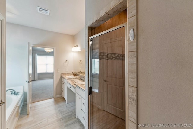 113 E 128th St S, Jenks, OK 74037 - bathroom featuring vanity, a shower stall, and a garden tub