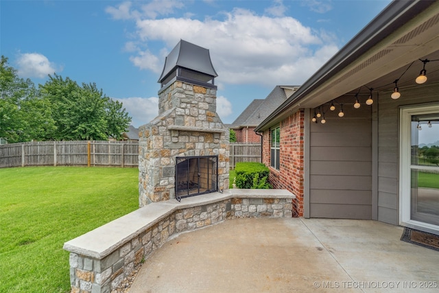 113 E 128th St S, Jenks, OK 74037 - fenced backyard with an outdoor stone fireplace and a patio area
