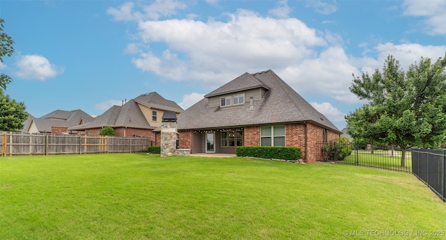 113 E 128th St S, Jenks, OK 74037 - back of property featuring brick siding, a fenced backyard, and roof with shingles
