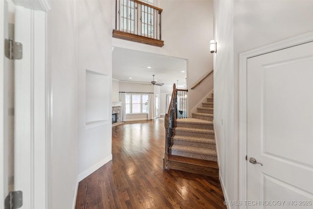 113 E 128th St S, Jenks, OK 74037 - stairway with wood finished floors, a stone fireplace, ceiling fan, and recessed lighting