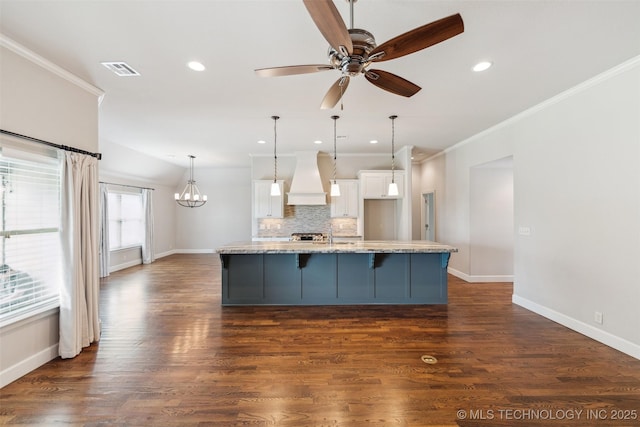 113 E 128th St S, Jenks, OK 74037 - kitchen featuring premium range hood, a kitchen bar, white cabinetry, backsplash, and ornamental molding