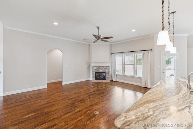 113 E 128th St S, Jenks, OK 74037 - unfurnished living room featuring ceiling fan, ornamental molding, arched walkways, dark wood-type flooring, and recessed lighting
