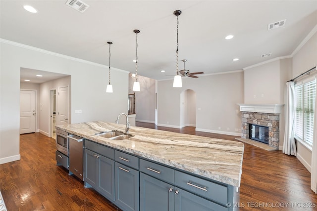 113 E 128th St S, Jenks, OK 74037 - kitchen featuring ceiling fan, appliances with stainless steel finishes, ornamental molding, arched walkways, and recessed lighting