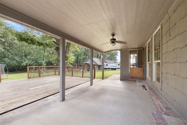 209 Shell Ln, Durant, OK 74701 - view of patio / terrace featuring a ceiling fan, a trampoline, a wooden deck, and view of scattered trees