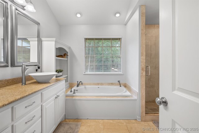 209 Shell Ln, Durant, OK 74701 - full bath with vanity, a bath, a stall shower, and tile patterned flooring