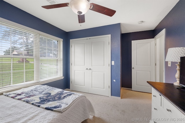 209 Shell Ln, Durant, OK 74701 - bedroom featuring light colored carpet, a closet, and a ceiling fan