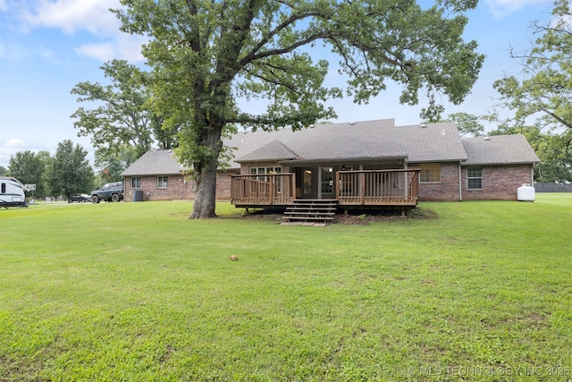 209 Shell Ln, Durant, OK 74701 - back of property with a deck, a lawn, brick siding, and a shingled roof