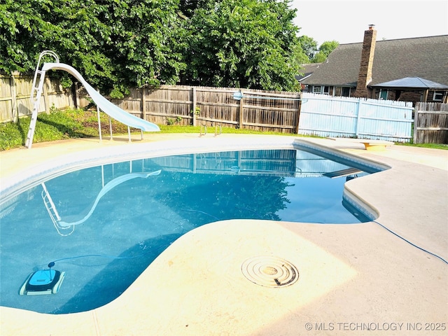 7936 S 72nd E Ave, Tulsa, OK 74133 - view of pool featuring a water slide, a fenced backyard, and a patio