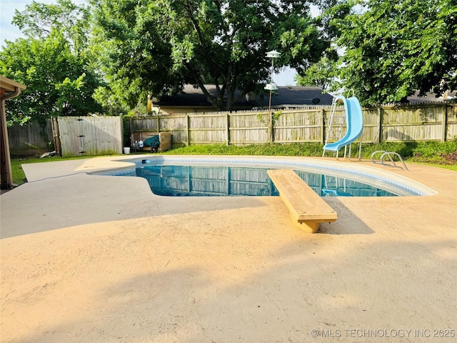 7936 S 72nd E Ave, Tulsa, OK 74133 - view of swimming pool featuring a water slide, a fenced backyard, and a patio