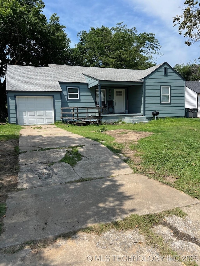 329 E Zion Pl, Tulsa, OK 74106 - ranch-style home with covered porch, a garage, a front lawn, driveway, and roof with shingles