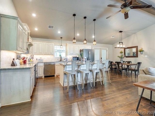 23997 County Road 1475th Loop, Ada, OK 74820 - kitchen with stainless steel appliances, a kitchen breakfast bar, tasteful backsplash, a kitchen island, and ceiling fan