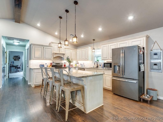 23997 County Road 1475th Loop, Ada, OK 74820 - kitchen with appliances with stainless steel finishes, a center island, light stone countertops, backsplash, and dark wood-style flooring
