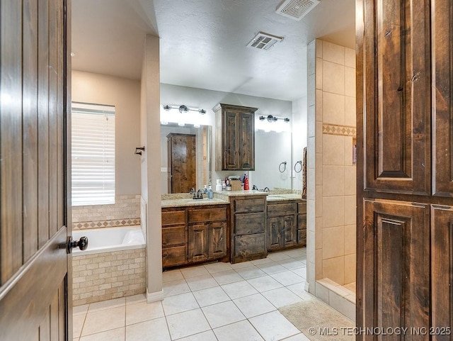 23997 County Road 1475th Loop, Ada, OK 74820 - full bathroom featuring double vanity, a bath, and tile patterned floors