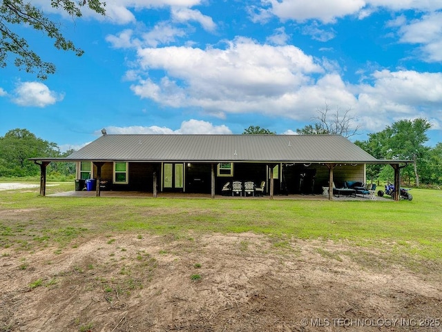 23997 County Road 1475th Loop, Ada, OK 74820 - back of property featuring a yard, a metal roof, and a carport