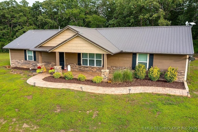 23997 County Road 1475th Loop, Ada, OK 74820 - view of front of house with stone siding, a front lawn, covered porch, and a metal roof