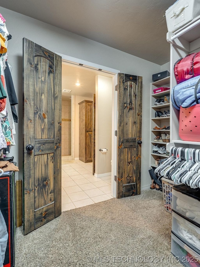 23997 County Road 1475th Loop, Ada, OK 74820 - walk in closet with carpet floors and tile patterned flooring