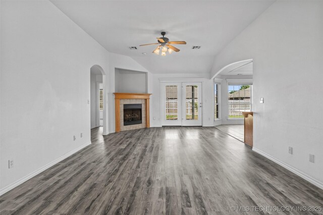 13124 N 133rd E Ave, Collinsville, OK 74021 - unfurnished living room featuring a ceiling fan, wood finished floors, arched walkways, lofted ceiling, and a fireplace