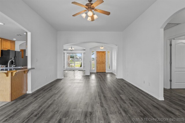 13124 N 133rd E Ave, Collinsville, OK 74021 - unfurnished living room with arched walkways, ceiling fan, dark wood-style floors, and recessed lighting