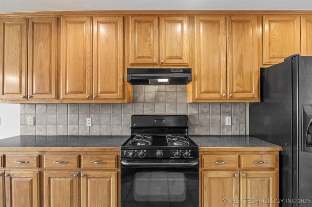 13124 N 133rd E Ave, Collinsville, OK 74021 - kitchen featuring black appliances, under cabinet range hood, dark countertops, and brown cabinetry