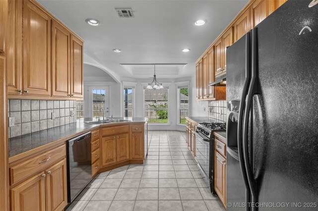 13124 N 133rd E Ave, Collinsville, OK 74021 - kitchen with black appliances, a tray ceiling, tasteful backsplash, light tile patterned flooring, and recessed lighting