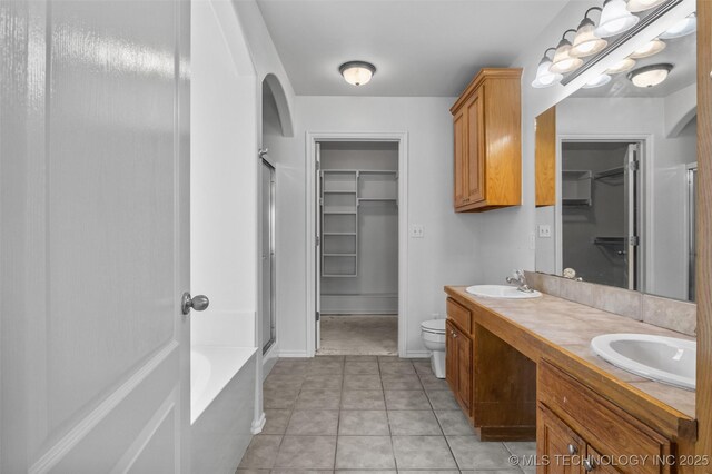 13124 N 133rd E Ave, Collinsville, OK 74021 - full bath featuring an enclosed shower, a spacious closet, double vanity, a tub, and tile patterned flooring
