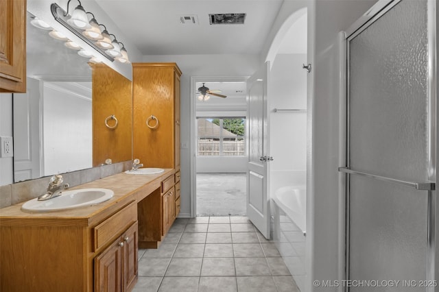13124 N 133rd E Ave, Collinsville, OK 74021 - full bath with double vanity, tile patterned flooring, a bath, ceiling fan, and an enclosed shower