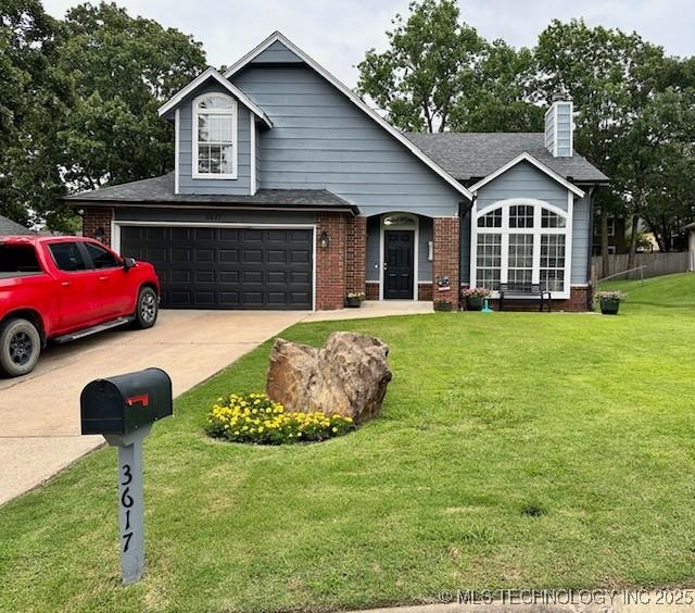 3617 S 74th W Ct, Tulsa, OK 74107 - traditional home with brick siding, concrete driveway, a chimney, and a shingled roof