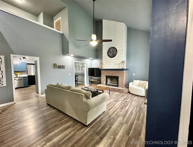3617 S 74th W Ct, Tulsa, OK 74107 - living area featuring ceiling fan, high vaulted ceiling, wood finished floors, and a brick fireplace