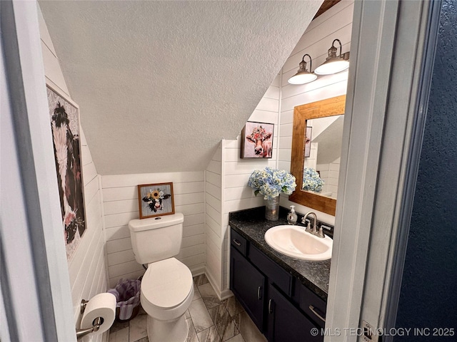 3617 S 74th W Ct, Tulsa, OK 74107 - half bathroom with a textured ceiling, vanity, and lofted ceiling